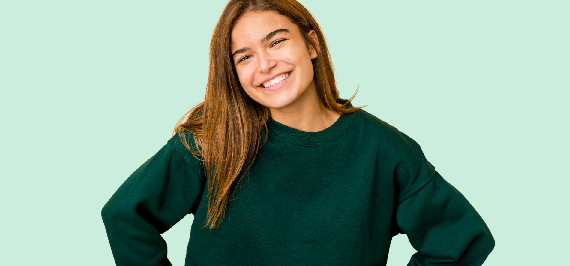 Female teenager smiling at the camera.
