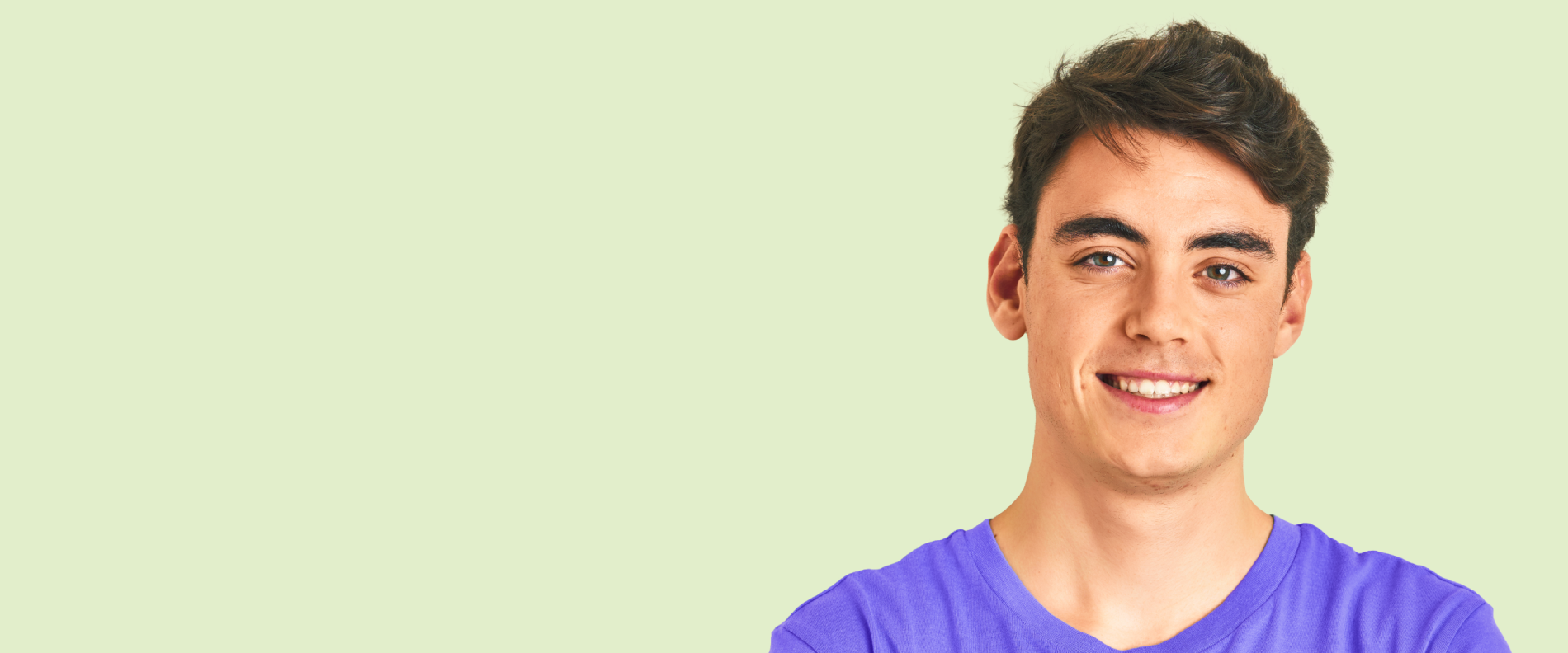 Older male teenager smiling confidently at camera.