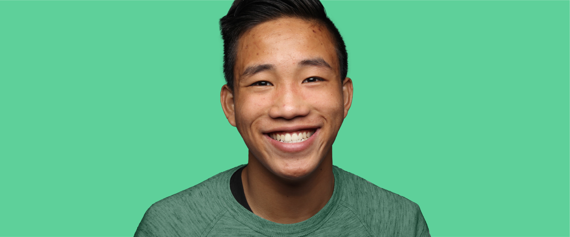 Close up of male teenager smiling. 
